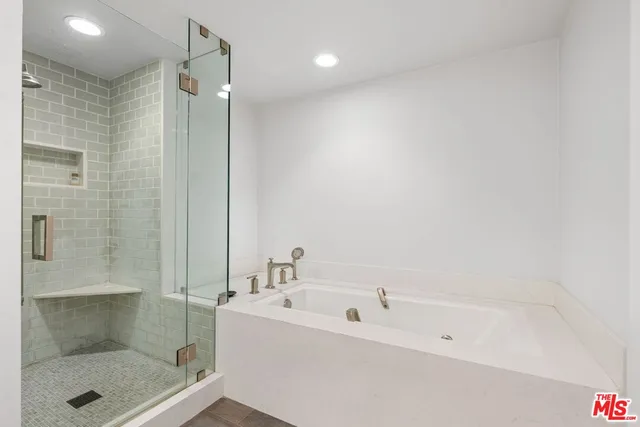 a bathroom with a bathtub and a shower
