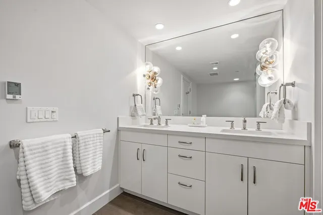 a bathroom with a double vanity sink and a mirror