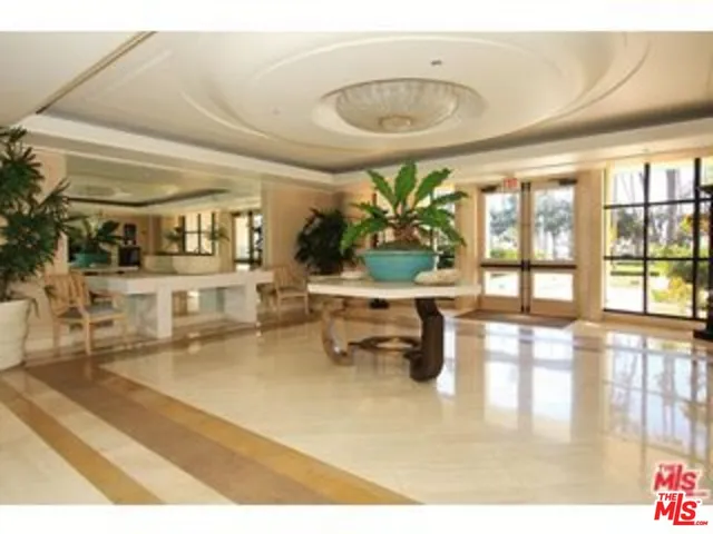 a lobby with furniture and floor to ceiling window