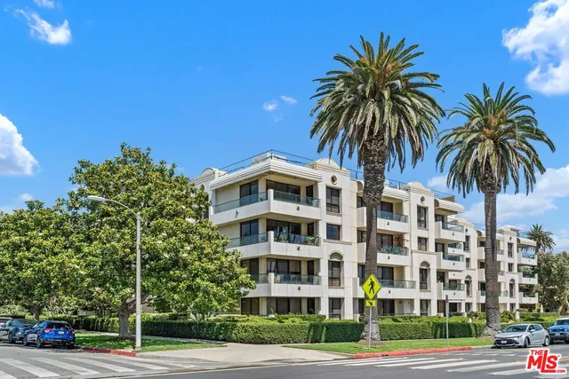 a front view of residential building and tree