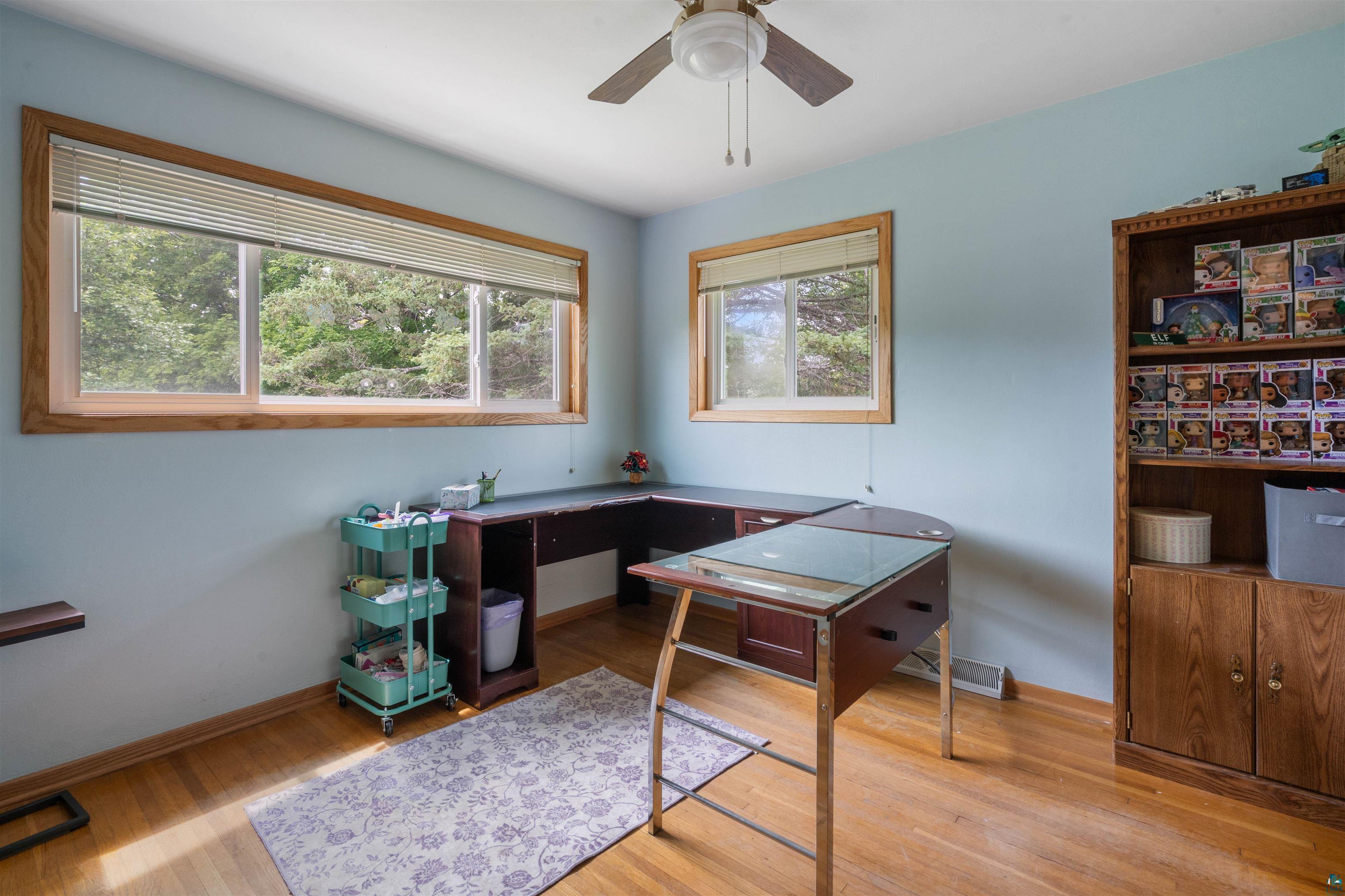3711 Getchell Road Hermantown, MN 55811 - Photo 15 of 31 Room featuring wood-finish flooring, light blue walls, and a ceiling fan with integrated lighting