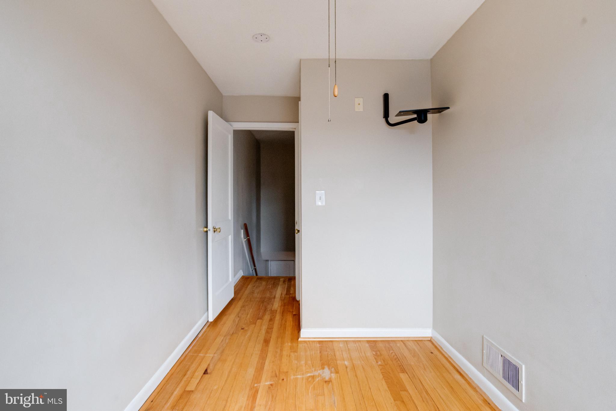 7455 Manchester Road Baltimore, MD 21222 - Photo 27 of 45 Bright and airy hallway with wooden floors.
