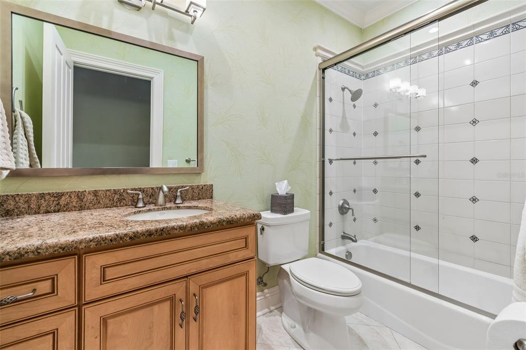 4804 Culbreath Isles Road Tampa, FL 33629 - Photo 44 of 70 a bathroom with a granite countertop sink toilet mirror and shower