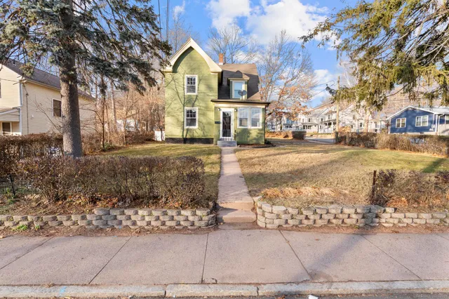 a view of a brick house with large windows