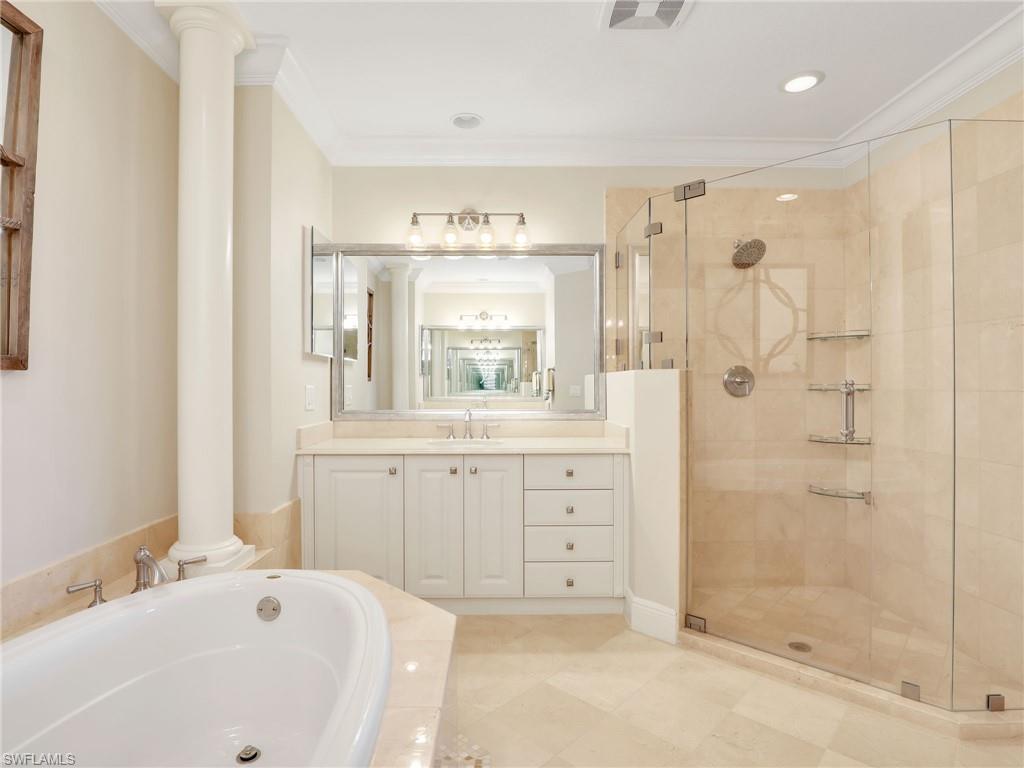 2718 Callista Court, Unit 101 Naples, FL 34114 - Photo 15 of 34 a bath room with a sink a mirror and a bath tub