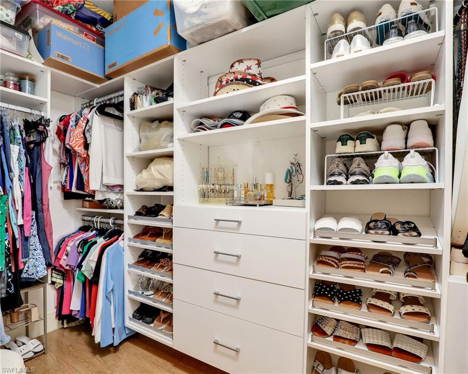 2718 Callista Court, Unit 101 Naples, FL 34114 - Photo 16 of 34 a view of walk in closet with clothes and shoes
