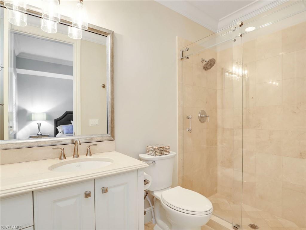 2718 Callista Court, Unit 101 Naples, FL 34114 - Photo 21 of 34 a bathroom with a sink a toilet and shower