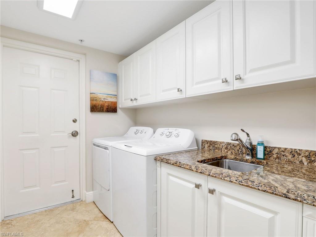 2718 Callista Court, Unit 101 Naples, FL 34114 - Photo 22 of 34 a kitchen with granite countertop white cabinets and sink
