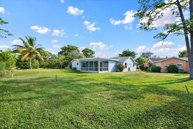 an aerial view of a house with garden space and street view