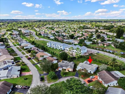 an aerial view of a houses with a yard