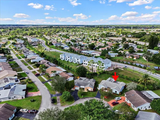 an aerial view of a houses with a yard