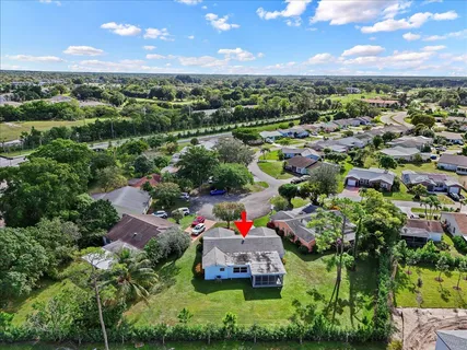 an aerial view of a houses with a yard