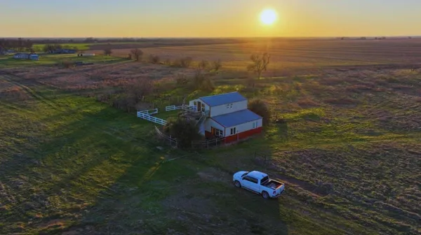 an aerial view of a house with a yard