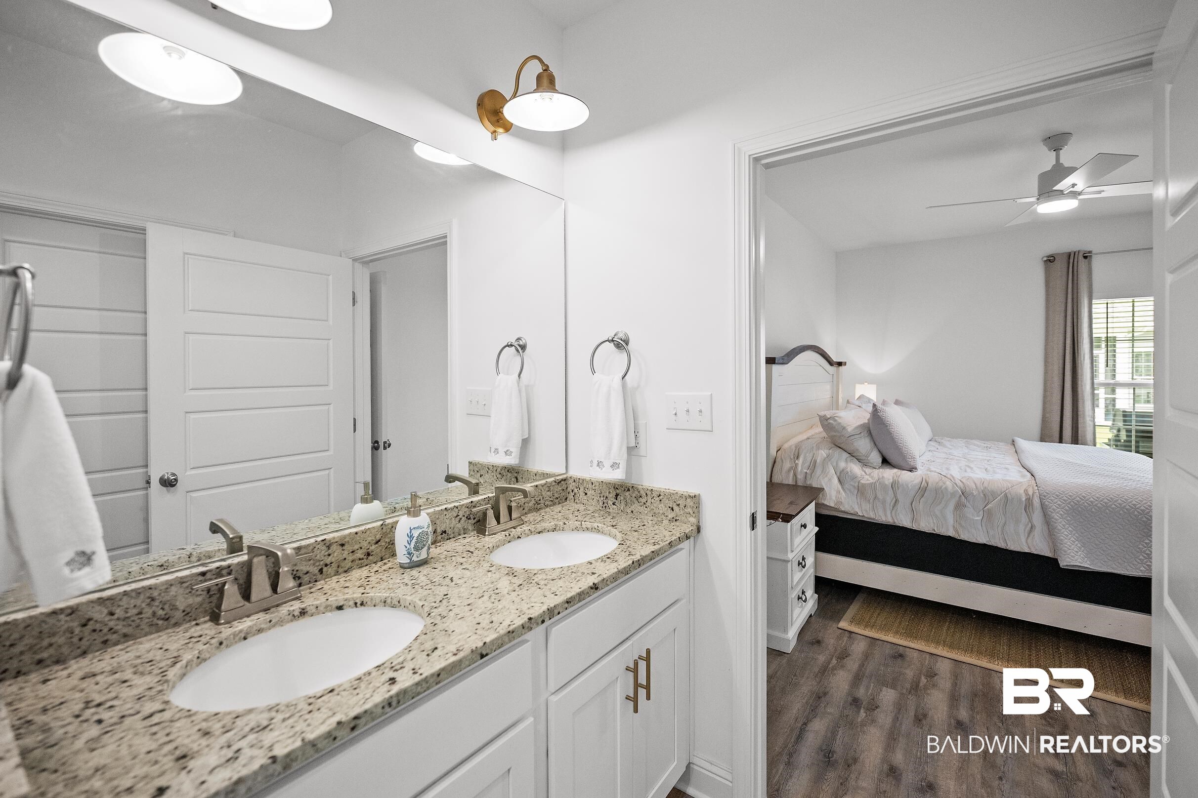 2651 South Juniper Street, Unit 2002 Foley, AL 36535 - Photo 14 of 23 Bathroom featuring a double vanity with granite countertop, undermount sinks, white cabinetry, and brushed nickel hardware