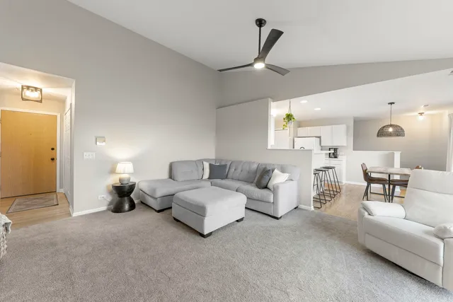 a living room with furniture and a chandelier