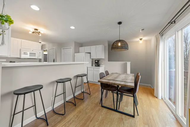 a view of a dining room with furniture and wooden floor