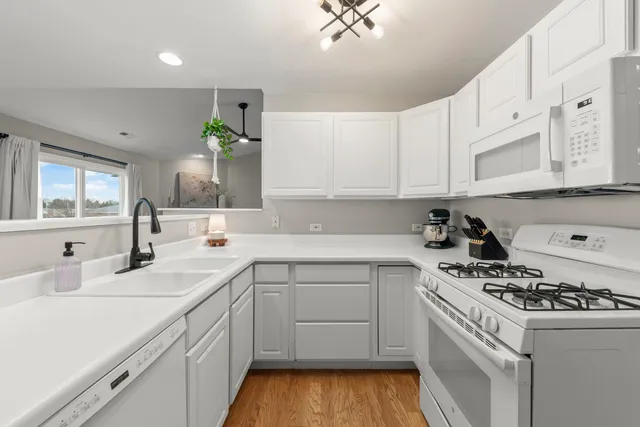 a kitchen with a sink stove and cabinets
