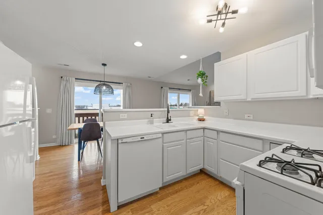 a kitchen with a sink appliances and cabinets