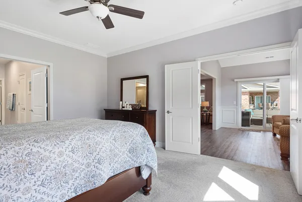 a bedroom with a bed and a chandelier