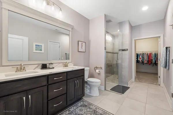 a spacious bathroom with a double vanity sink mirror and toilet