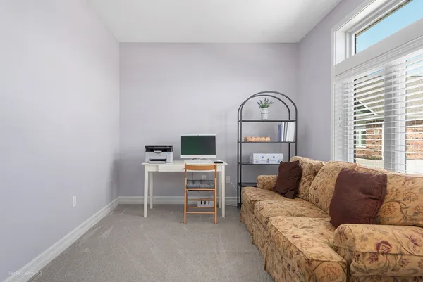 a living room with a couch and a stove top oven