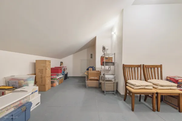 a room with furniture a air conditioner vent and a desk
