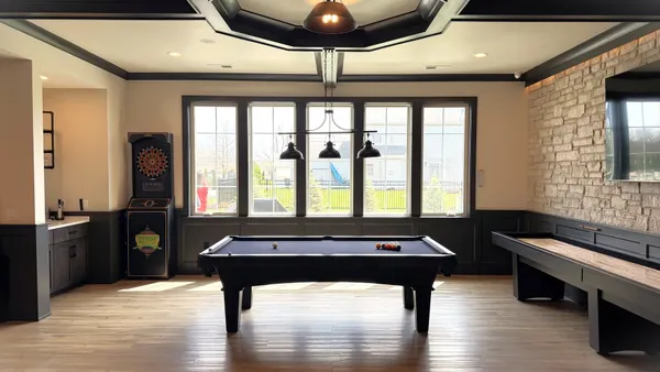 a room with furniture pool table and windows