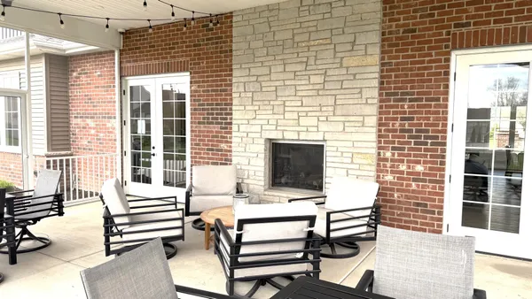 a backyard of a house with outdoor seating