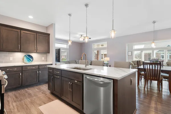 a kitchen with a sink a counter space appliances and cabinets