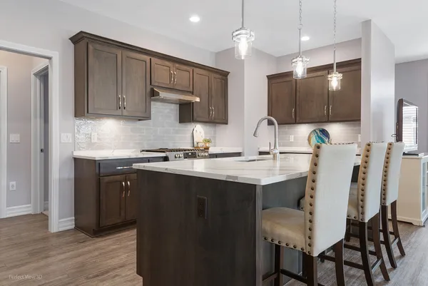 a kitchen with a sink cabinets and wooden floor