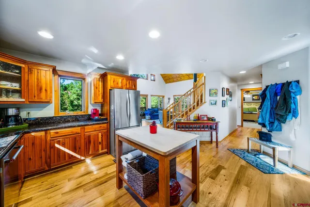 a living room with lots of furniture and kitchen view