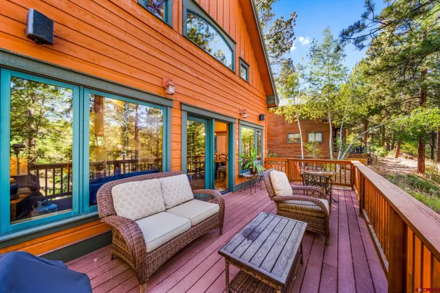 a balcony with wooden floor and furniture