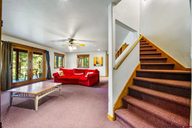 a bedroom with furniture and a large window