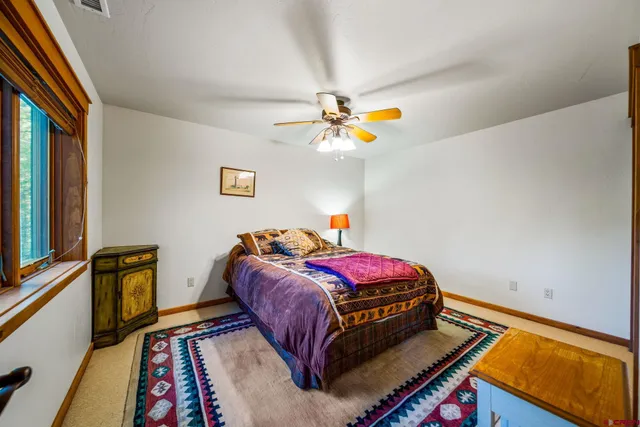 a bed room with a bed and a window