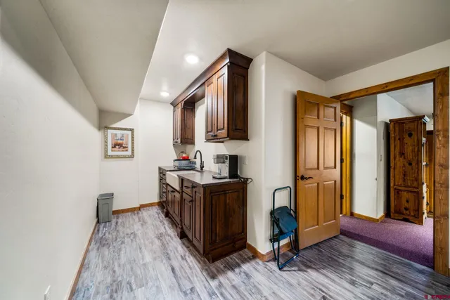a view of kitchen with furniture and wooden floor