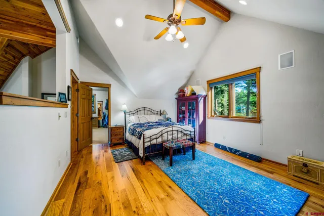 a spacious bedroom with a bed and a chandelier