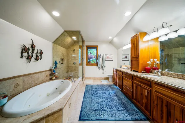 a large spacious bathroom with a large tub and sink
