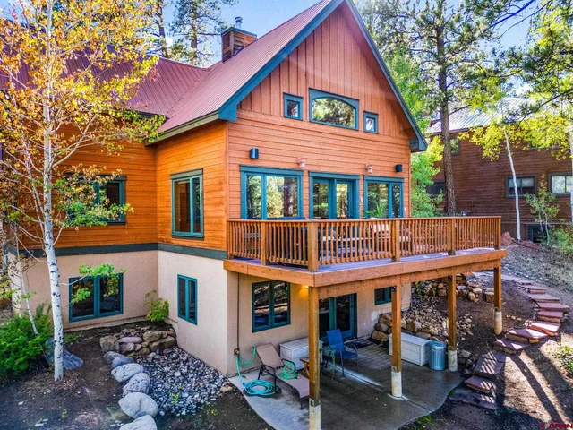 a view of a house with a yard and potted plants