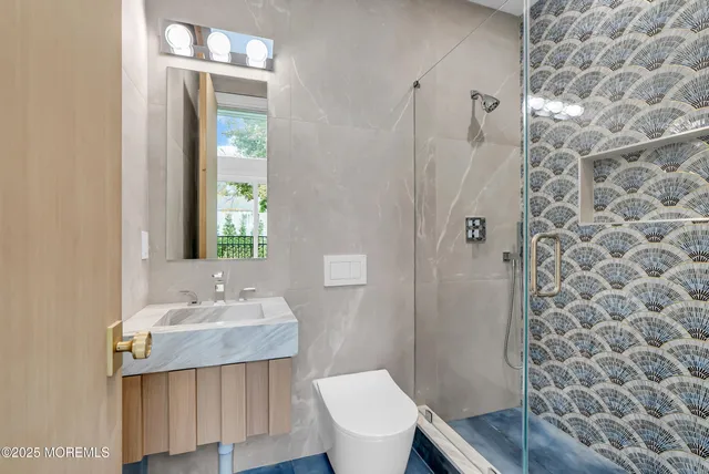 a bathroom with a sink toilet and shower