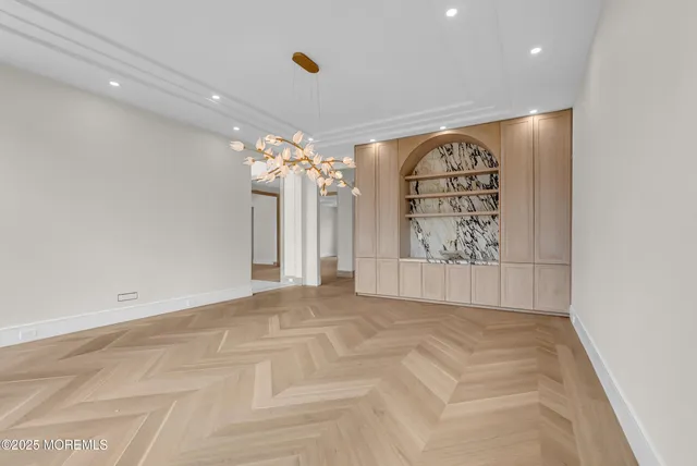 a view of an empty room with a chandelier