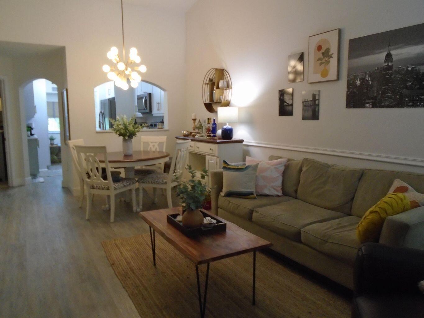 3760 North Jog Road, Unit 204 West Palm Beach, FL 33411 - Photo 3 of 28 a living room with furniture and a chandelier