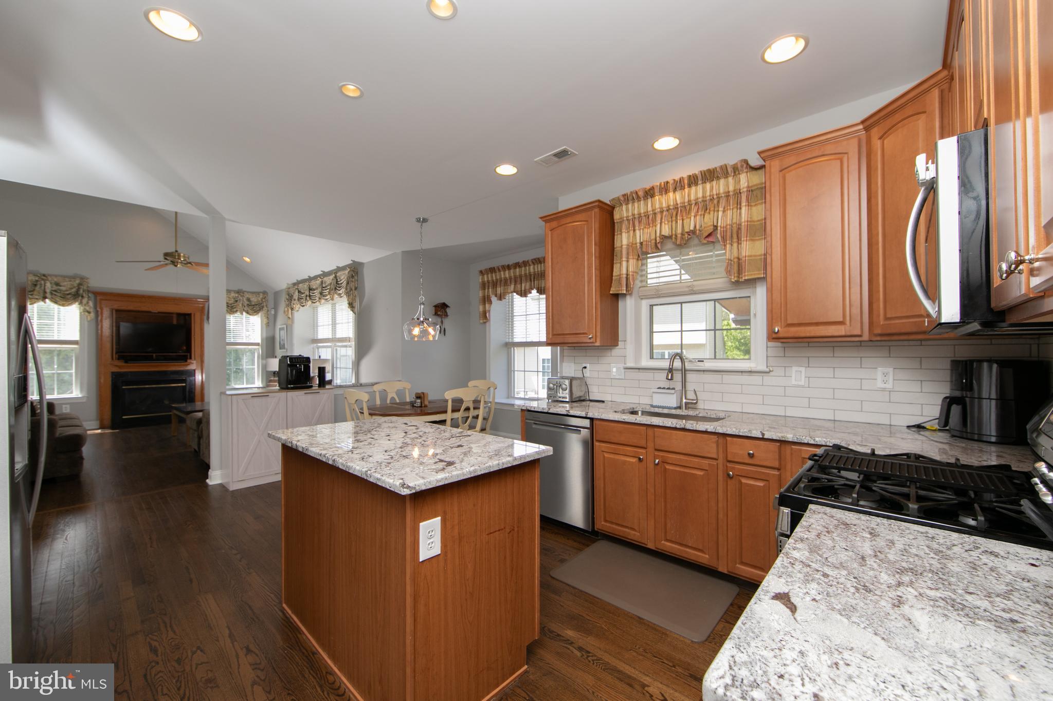7 Kyle Court Mount Laurel, NJ 08054 - Photo 20 of 67 a kitchen with stainless steel appliances granite countertop wooden cabinets a sink dishwasher and a stove top oven with wooden floor