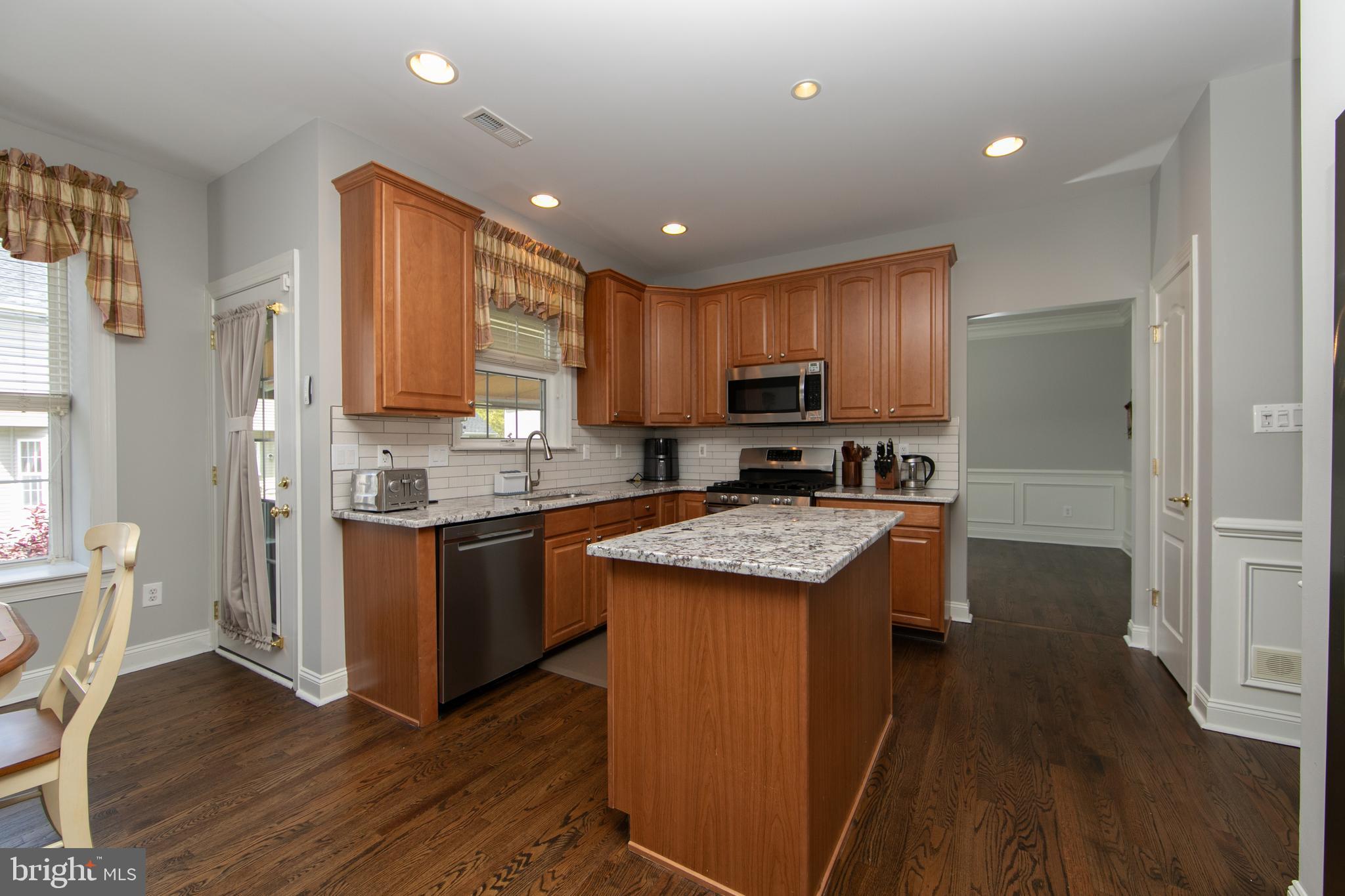 7 Kyle Court Mount Laurel, NJ 08054 - Photo 21 of 67 a kitchen with granite countertop kitchen island wooden floors wooden cabinets a center island and stainless steel appliances