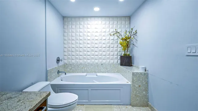 a bathroom with a granite countertop sink mirror and shower