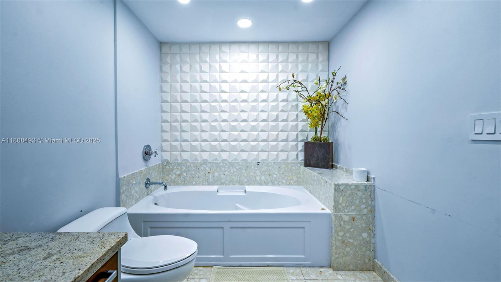 185 Southwest 7th Street, Unit 2911 Miami, FL 33130 - Photo 20 of 33 a bathroom with a granite countertop bathtub sink and toilet