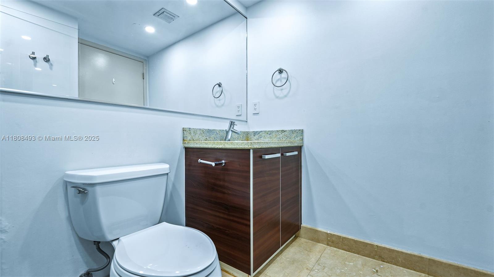 185 Southwest 7th Street, Unit 2911 Miami, FL 33130 - Photo 26 of 33 a bathroom with a granite countertop toilet and a sink