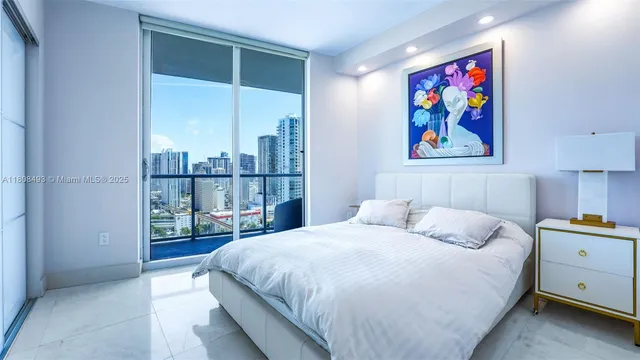 a large white bed in a hotel room
