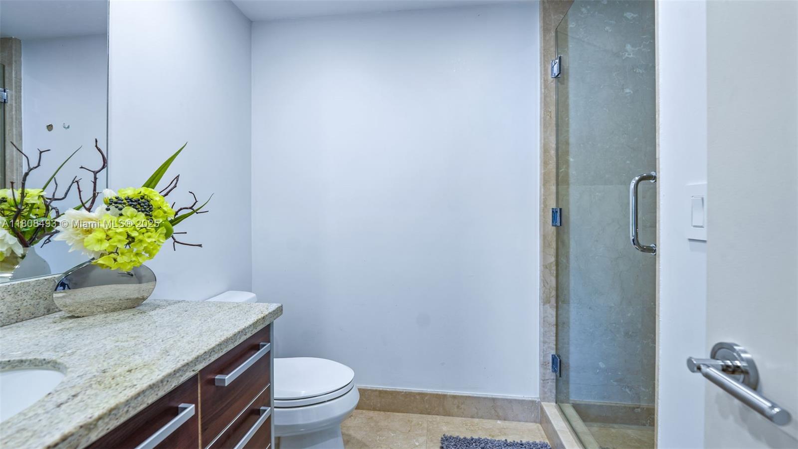 185 Southwest 7th Street, Unit 2911 Miami, FL 33130 - Photo 30 of 33 a bath room with a granite countertop toilet and a sink