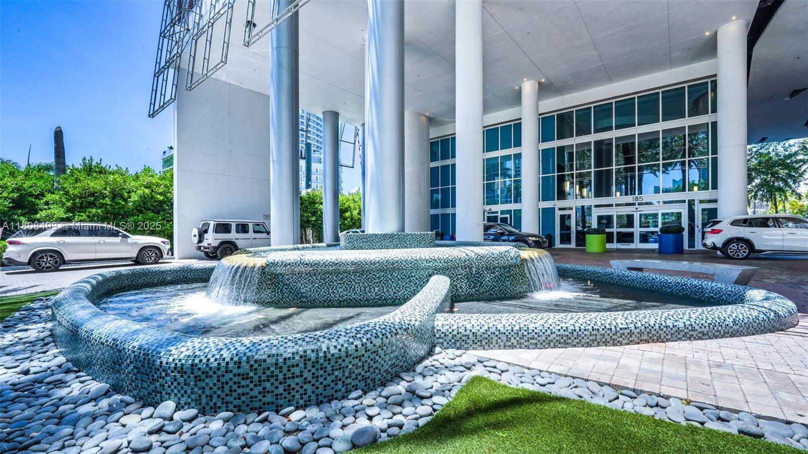 185 Southwest 7th Street, Unit 2911 Miami, FL 33130 - Photo 32 of 33 a view of a building with couches and pool