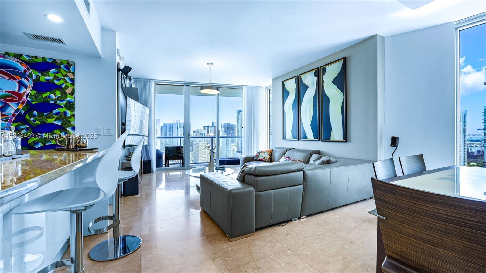 185 Southwest 7th Street, Unit 2911 Miami, FL 33130 - Photo 6 of 33 a living room with furniture and a potted plant